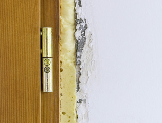 Part of an wooden door and Polyurethane foam. - obrazy, fototapety, plakaty