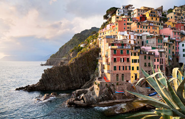 Fototapeta na wymiar Beautiful town of Riomaggiore - the first of the Five Lands of the Italian National Park Cinque Terre the Ligurian coast in the sunset