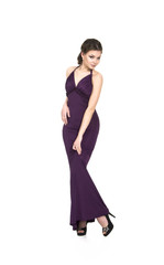 A young,smiling girl in dress posing on a white background. Studio shot, isolated image.