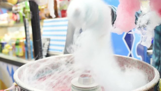 Man hand making cotton candy with cotton candy machine