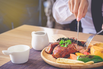 Businessmen are eating steak, pork pie and practice knife.