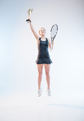 woman with racket and trophy