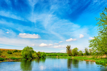 Fototapeta na wymiar View to river banks with green trees