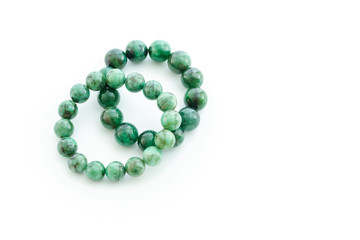 Beautiful valuable Emerald stone beads in bracelet on white background