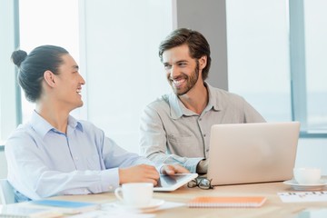 Business executives discussing with each other 