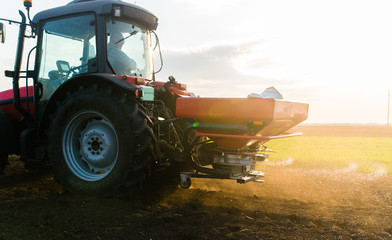 Tractor spreading artificial fertilizers