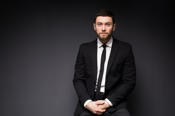 Elegant man close up portrait against dark background.