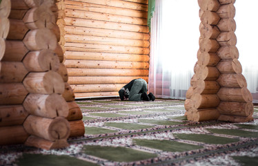 Bearded man praying in the mosque