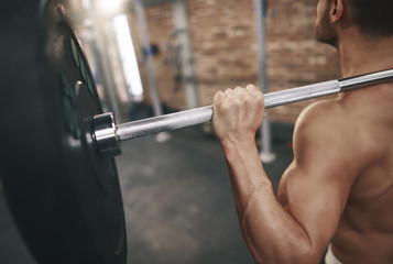 Fototapeta na wymiar Rear view of man building triceps
