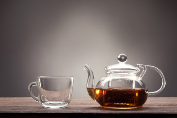 teapot and cup of tea on wooden table