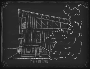 A sketch of a building using white chalk on a chalkboard.