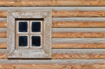 background light brown wooden wall hut made of logs with a square window