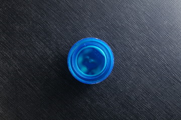 The dirty blue color plastic detergent bottle cap represent the bottle and containing packaging concept related idea.