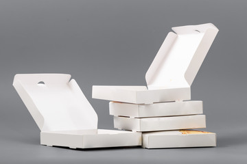 Pizza boxes on a gray background. Isolate
