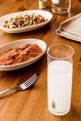 Turkish Drink Raki with acili ezme and gavurdagi salad with walnut. 