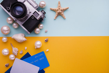 Travel accessories on blue and yellow background. Essential vacation items. Travel concept, top view.