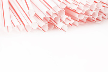 Red and white drinking straws on the white - studio shot