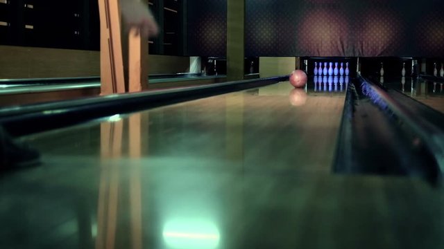 Young woman is throwing ball in a bowling club Slow motion