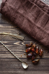 Dried date fruit on the old wooden table.