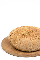Round domestic bread isolated with wooden board