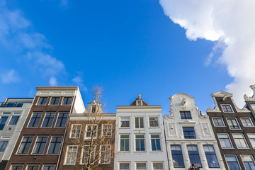 Fototapeta premium Old buildings in Amsterdam in sunny day