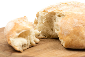 Round domestic bread sliced on the wooden board