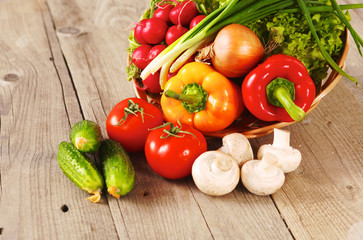 Composition with assorted raw organic vegetables wooden table