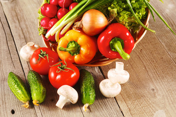 Composition with assorted raw organic vegetables wooden table