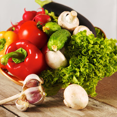 Composition with assorted raw organic vegetables wooden table