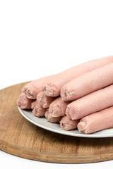 Cooked hot dogs served on the plate over white background