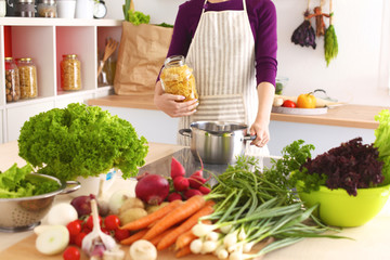 Young Woman Cooking in the kitchen. Healthy Food