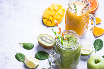 Green and yellow smoothie in mason jar. Mango and spinash drinks. Healthy food and diet.