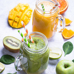 Green and yellow smoothie in mason jar. Mango and spinash drinks. Healthy food and diet.