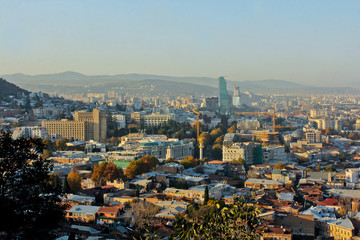View to Mtatsminda distric of the Tbilisi of Republic of Georgia. View of the Freedom Square, high Biltmor Hotel and other buildings.
