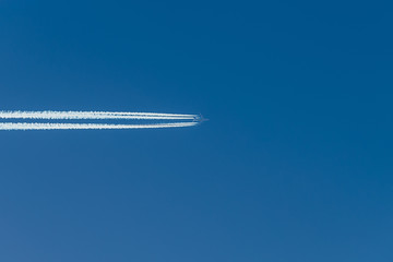 Trace from the plane in a blue sunny sky