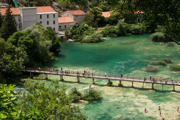 Fototapeta na wymiar Aerial view of waterfall Skradinski Buk and wooden bridge across the river in Krka National Park, Croatia