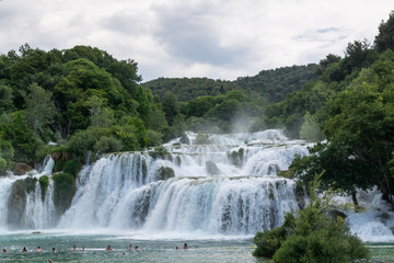 Unidentified tourists swim in waterfall  Skradinski Buk of Krka river in the Krka National Park in Croatia.