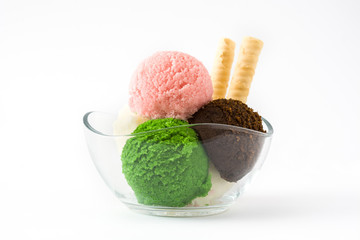 Ice cream scoops in crystal bowl, isolated on white background. Copyspace.
