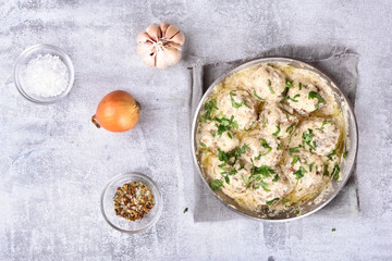 Meatballs with white sauce in pan