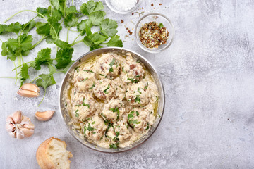 Meatballs with white sauce in pan