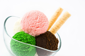 Ice cream scoops in crystal bowl, isolated on white background. Copyspace.
