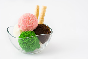 Ice cream scoops in crystal bowl, isolated on white background. Copyspace.
