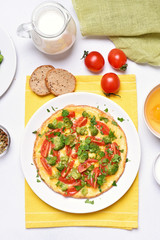 Omelet with broccoli, tomato and green herbs