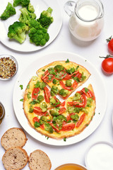 Omelet with broccoli, tomato and green herbs