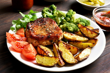 Grilled meat with vegetables on plate