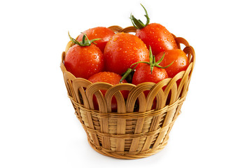 Fototapeta na wymiar Fresh cherry tomatoes in woven basket isolated on white background
