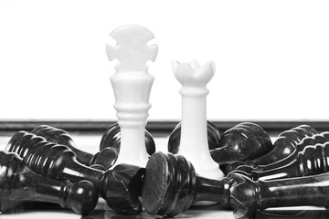 Black and white chessmen on chessboard