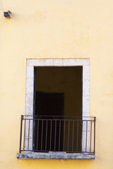 Fototapeta na wymiar Balcony on a colorful building in Mexico. Simplicity.