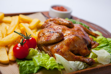 Chicken with potato and other vegetables on pan.