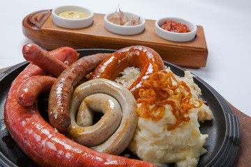 Assorted grilled sausages with mashed potatoes